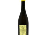 a bottle of wine sitting on top of a white table