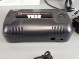 a small black car charger sitting on a table next to a keyboard