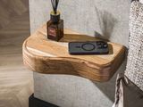 a wooden shelf with a remote control on top of it
