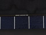 a close up of a black purse with a blue and white stripe lining