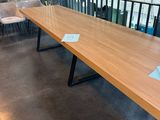 a long wooden table with blue tags on it