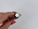 a woman ' s hand holding a chocolate bar with a star on it