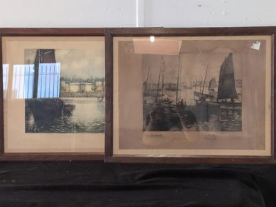 two framed pictures of boats on the water in a room