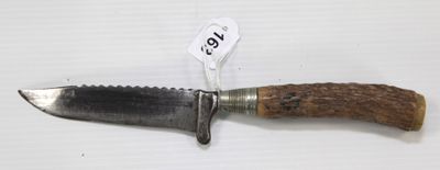 a knife that is sitting on top of a piece of wood