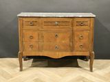 an antique chest of drawers with marble top on a wooden floor