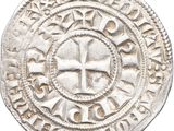une vieille pièce d'argent ornée d'une croix