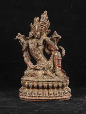 a bronze figure of a seated buddha on a pedestal