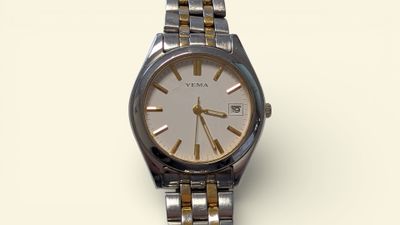 a silver and gold wrist watch on a white surface