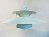 a light blue pendant lamp hanging from a white wall