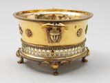 an image of a gold plate with an egyptian design on it
