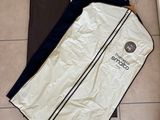 a picture of a suit bag on the floor next to a door