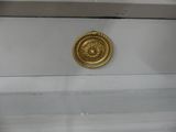 a gold plate on the side of a window sill