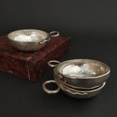 a silver bowl and a silver bowl on a wooden stand