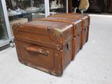 three old suitcases sitting on the floor in a store