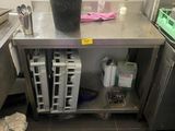 a kitchen with a sink, stove, and other items on the floor