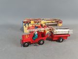 a red toy fire truck with a ladder and a box