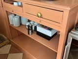 a coffee maker on a shelf in a kitchen