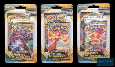 three packs of pokemon trading cards are shown in a row