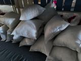 a pile of pillows sitting on the floor in front of a crib