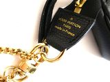a black purse with a gold chain attached to it