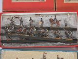several toy soldiers are in a box on a white surface