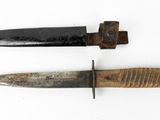 two knives on a white surface one has a wooden handle and the other has a black handle
