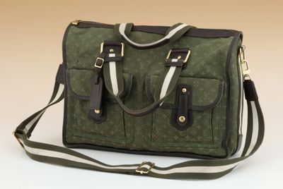 a green and black bag with a strap on it