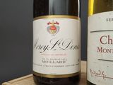 two bottles of wine sitting on a wooden table
