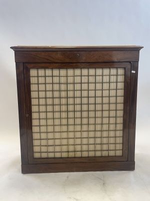 an old wooden cabinet with a glass door on top of it