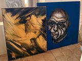 two paintings of a man and a woman are on a tile floor