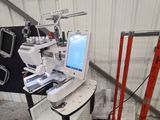 a laptop computer sitting on top of a sewing machine