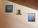 pictures on the wall above a bed in a room