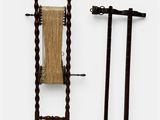 two brooms and a broom stand next to each other