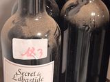 several bottles of wine are lined up on a shelf in a store