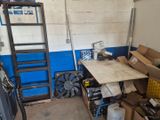 a room with a table and a ladder in it