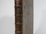 an old book sitting on top of a white surface