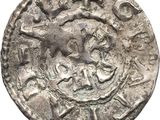 a silver coin with an image of a horse on it