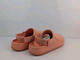 pink baby shoes with bows on them on a white surface