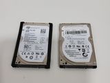 two hard drives are sitting side by side on a table