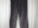 a pair of black pants hanging on a white curtain