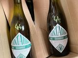 two bottles of beer in a cardboard box on a table