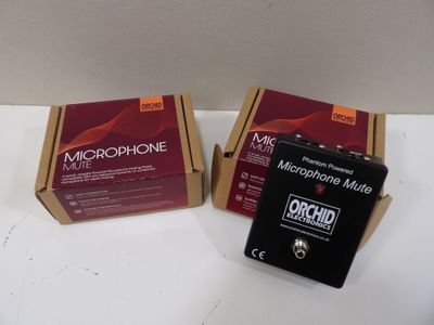two boxes of microphone mics sitting on a table