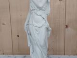 marble statue of a woman holding a vase on a marble table
