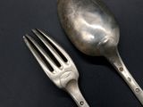 a fork and a spoon on a black surface