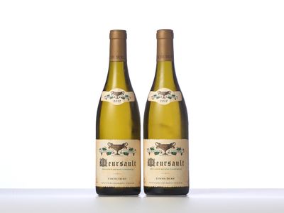 two bottles of white wine sitting on top of a table