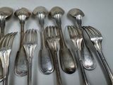 a lot of forks and spoons that are on the table