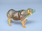 a figurine of a rhino with a yellow ribbon around its neck