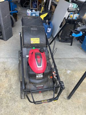 an image of a lawn mower parked in a garage