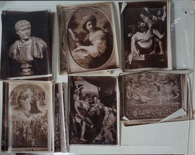 many old photos of people on display in a glass case
