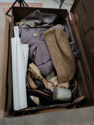 une boîte remplie de vêtements et une paire de chaussures